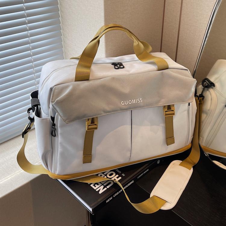 Cream travel duffel bag with yellow-brown handles and front zipper pocket
