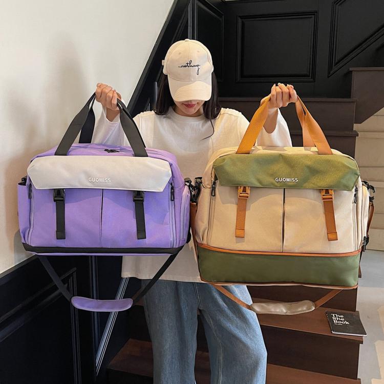 Two travel duffel bags: purple and green with front zip pockets and adjustable straps