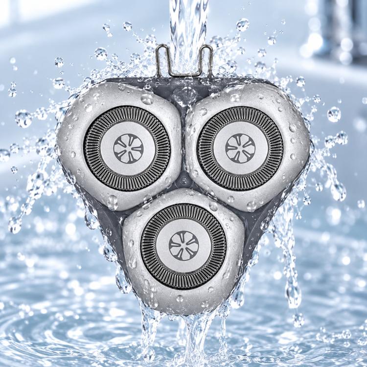 Rotary shaver head with three wet-use foils, water droplets on silver blades
