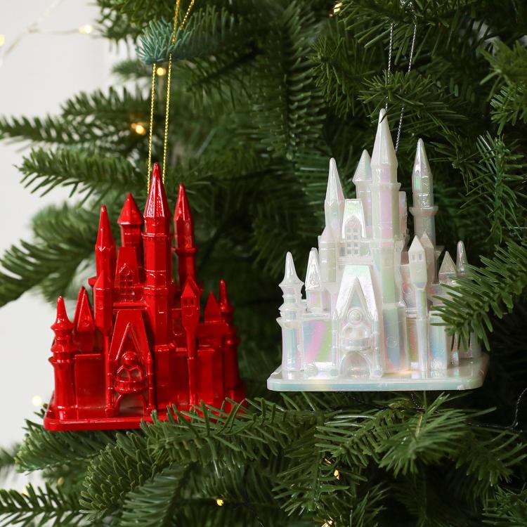Hanging red and white acrylic castle ornaments on evergreen branches, 3D fairytale design