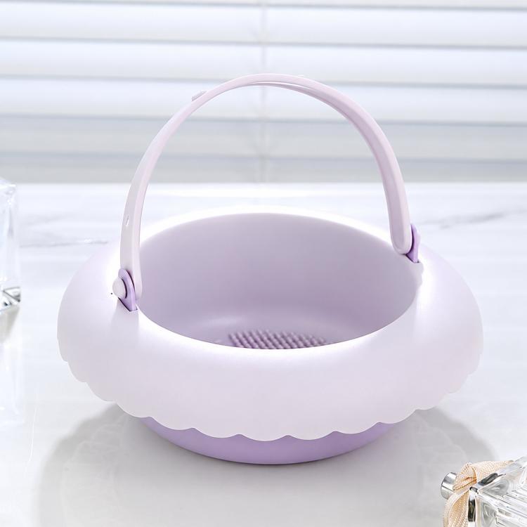 Purple silicone makeup brush cleaning bowl with handle and drain mat base