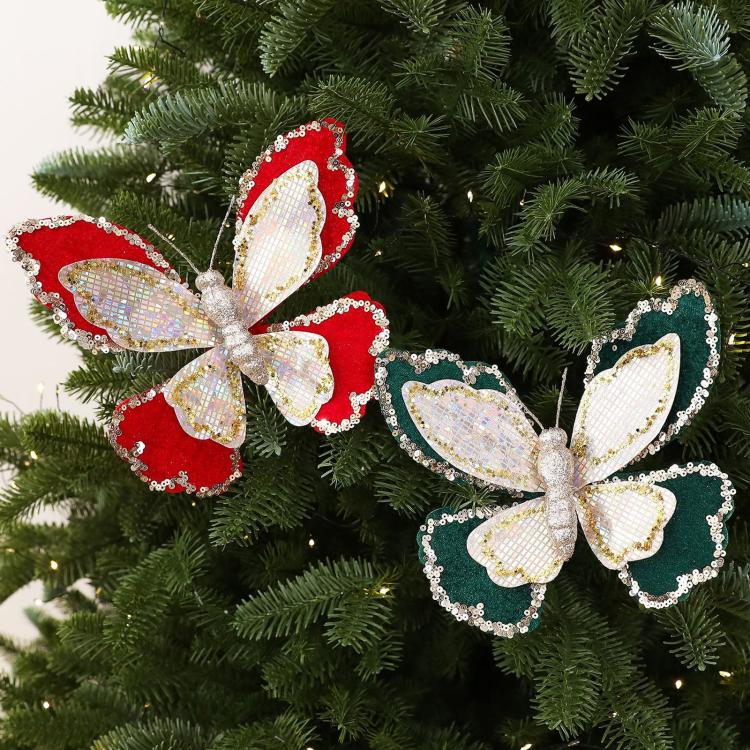 Two double-layer sequin butterfly ornaments on tree branches, red and dark green with gold trim
