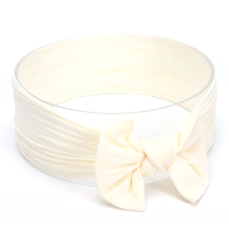 Infant hair bow headband in cream with oversized front bow