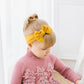 Infant hair bow headband in mustard yellow with big bow worn by baby