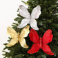 Silver, gold, and red glitter butterfly ornaments on a Christmas tree