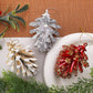 Assorted pinecone-style Christmas tree ornaments in white, gold, and red