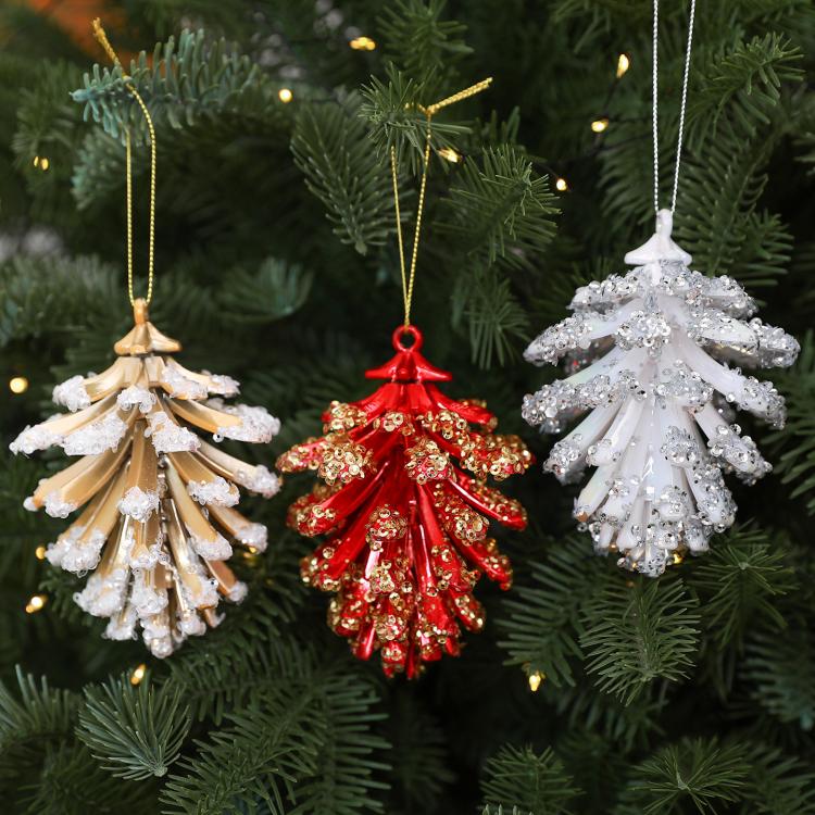 Set of pinecone-style Christmas tree ornaments in gold, red, and white