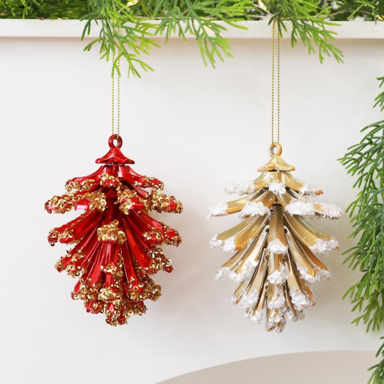 Red and gold pinecone-style Christmas tree ornaments hanging from loops
