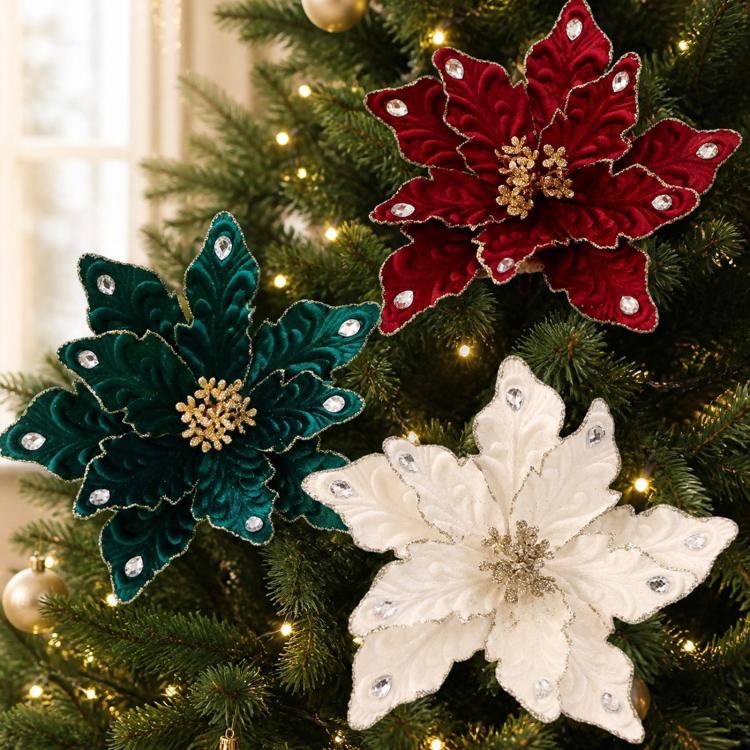 Velvet poinsettia ornaments in teal, red, and white on a decorated Christmas tree