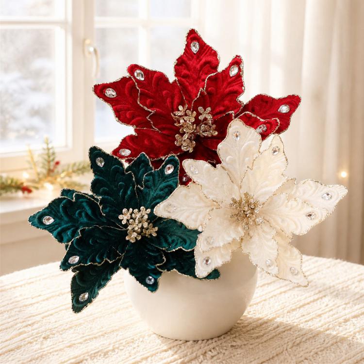 Wine red, teal, and white velvet poinsettia ornaments on a ceramic pot