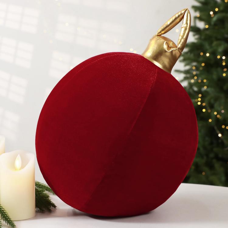 Red velvet inflatable Christmas ball ornament close-up with gold loop cap