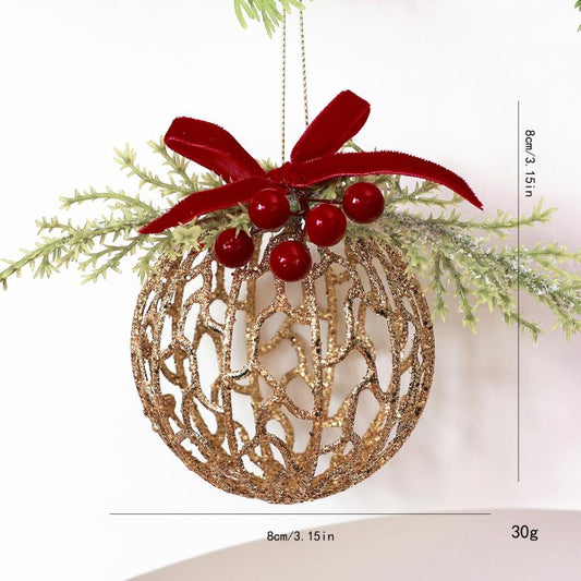 Gold glitter hollow ball ornament with red velvet bow, red berries, and hanging loop