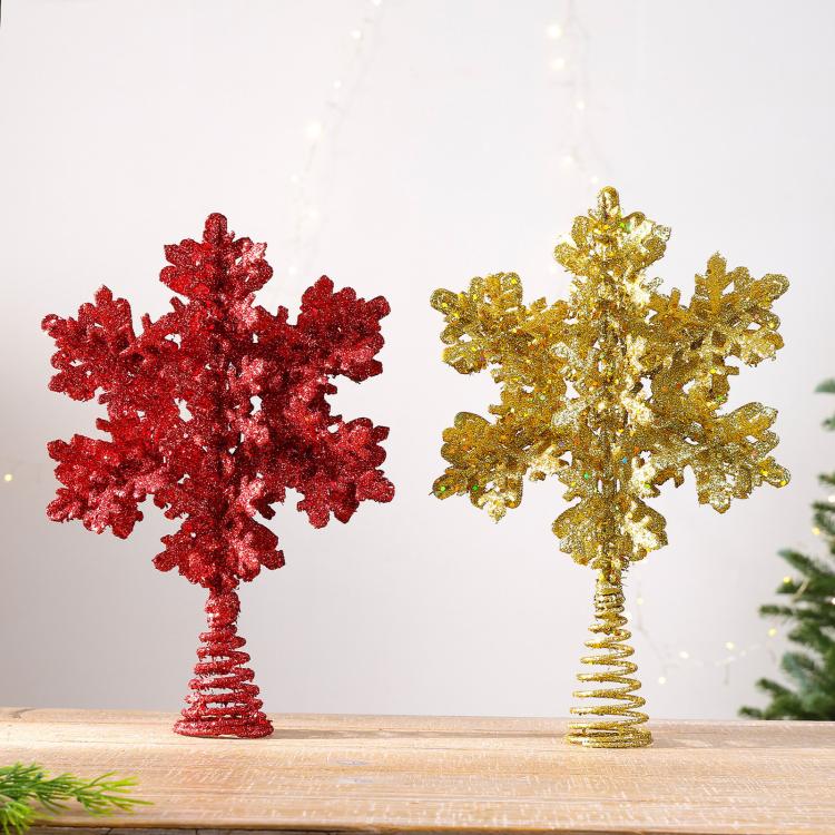 Glitter snowflake tree toppers in red and gold, each with spiral metal stem