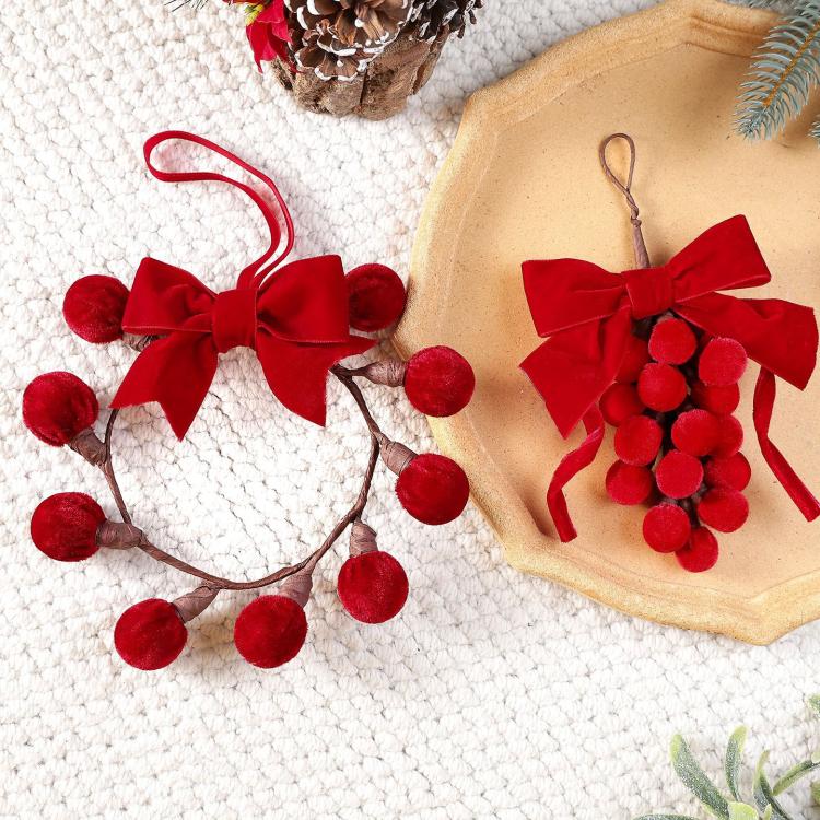 Red ribbon bow grape-cluster wreath ornament with fuzzy pom berries