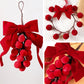 Red ribbon bow pom-berry wreath ornament, close-up view