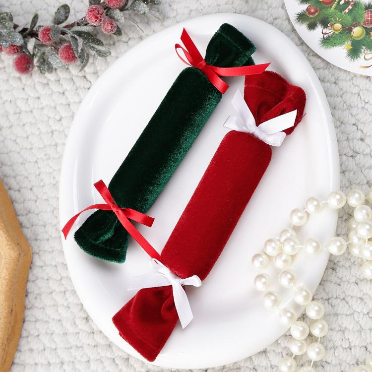 Green and red velvet plush candy ornaments with ribbon bows on a white plate