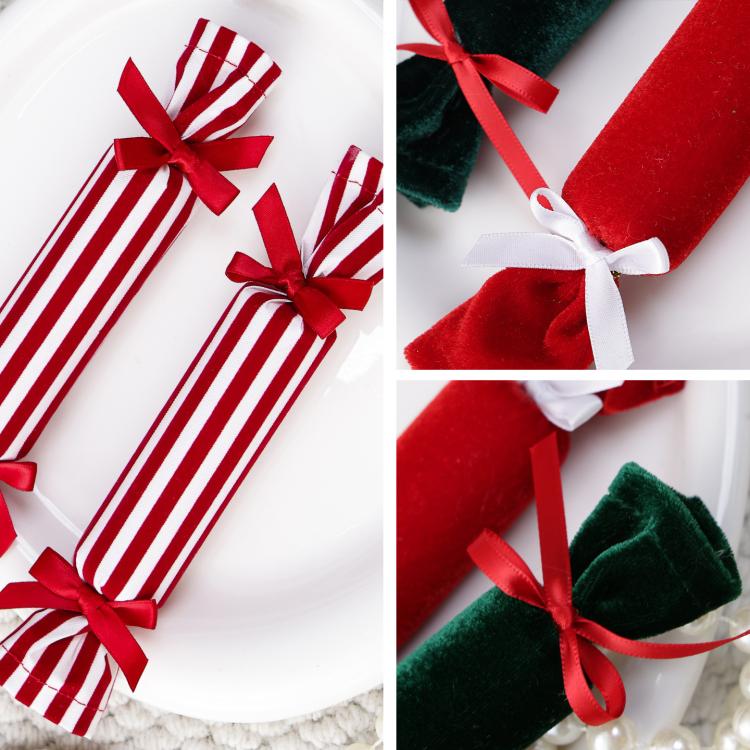 Close-up of striped and velvet plush candy ornaments with red ribbon bows