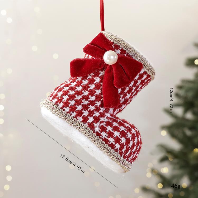 Red-and-white patterned Christmas boot ornament with red velvet bow and pearl bead.