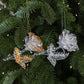 Clear acrylic rose Christmas ornaments on pine branches, gold and white beaded details