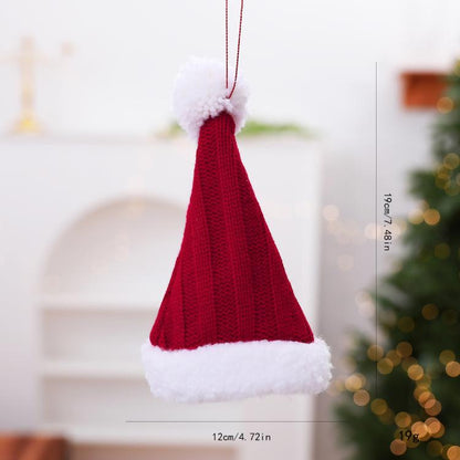 Mini knitted red Christmas hat ornament with white trim, pom top, hanging loop.