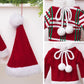Close-up mini knitted sweater ornament: red knit with green/white stripes and bow pom.