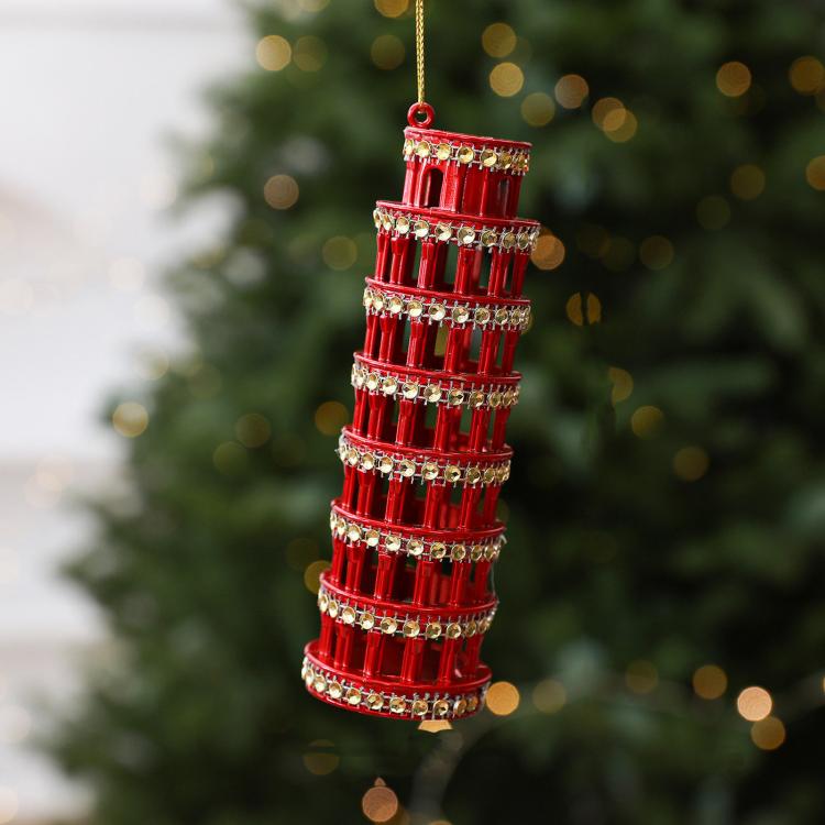 Diamond-studded leaning tower ornament in red with hanging loop and metallic accents