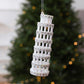 Diamond-studded leaning tower ornament in white with hanging loop and metallic accents