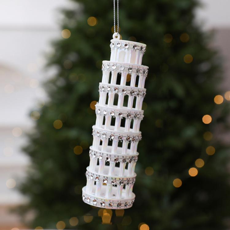 Diamond-studded leaning tower ornament in white with hanging loop and metallic accents
