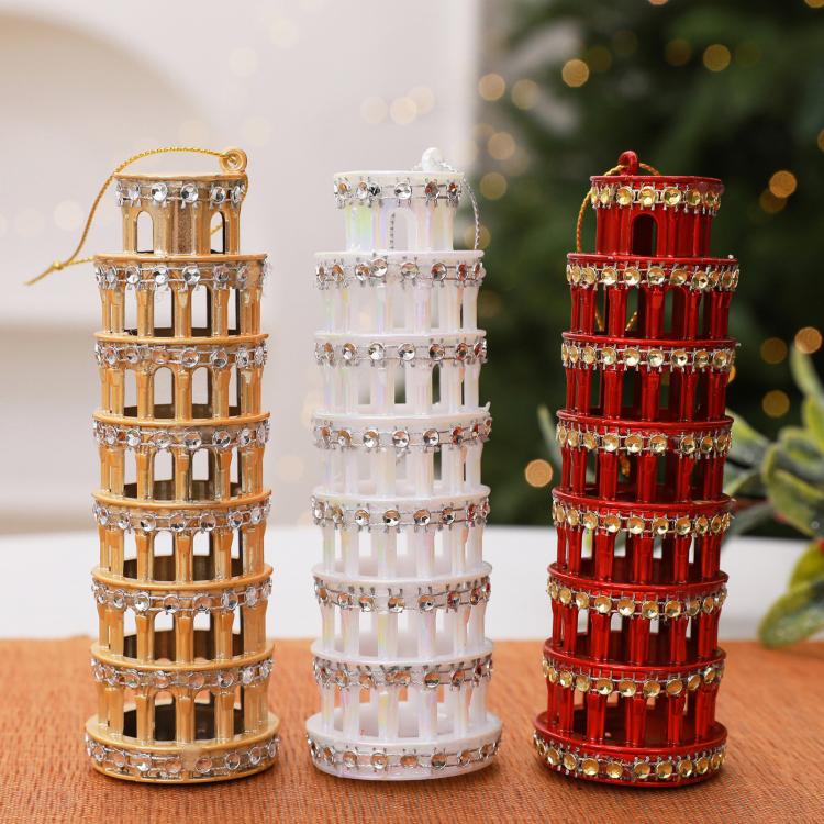 Diamond-studded leaning tower ornaments: gold, white, and red, standing side by side
