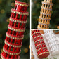 Close-up diamond-studded leaning tower ornaments: red and gold with faceted details