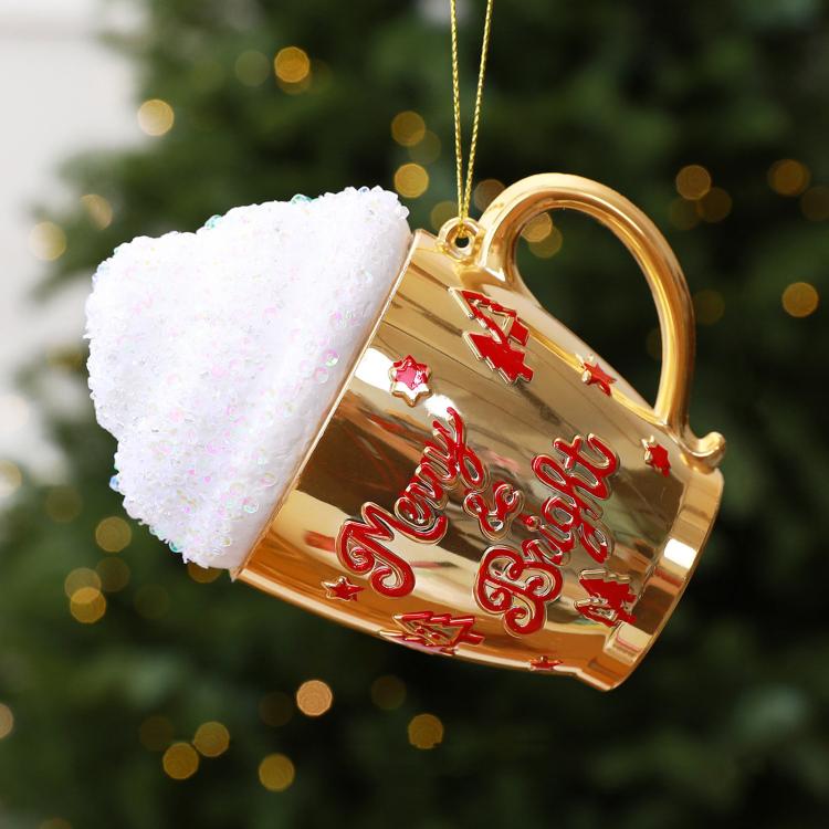 Gold cup-shaped Christmas ornament with glittered white cap and red holiday lettering