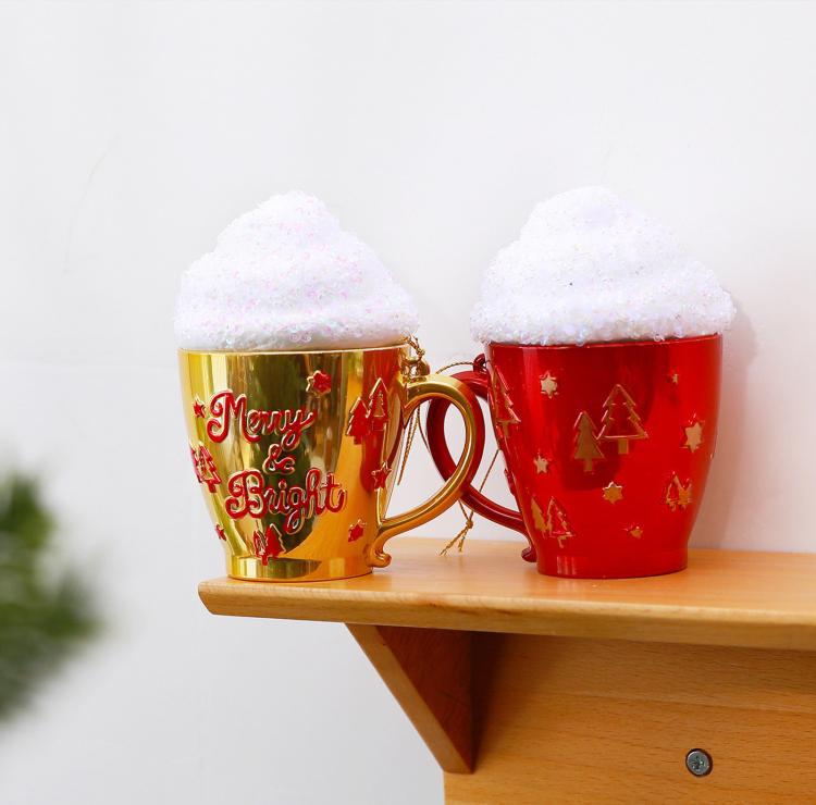 Gold and red cup-shaped Christmas ornaments with glittered caps on a wooden shelf