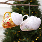 Hanging set of gold and white cup-shaped Christmas ornaments with glittered caps and charms