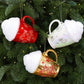 Cup-shaped Christmas ornaments in red, white, and gold with glittered caps on a tree