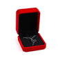 Red octagonal velvet jewelry box, open with silver-tone chain cross pendant