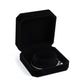 Black octagonal velvet jewelry box, open with bracelets on inner cushion