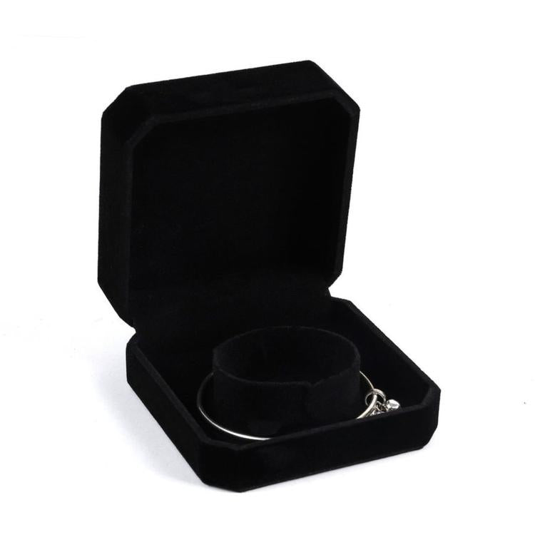 Black octagonal velvet jewelry box, open with bracelets on inner cushion
