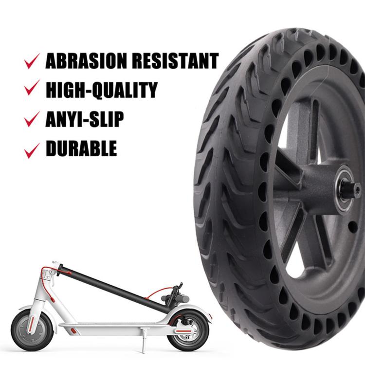 Black solid rear wheel and disc brake rotor, shown with scooter