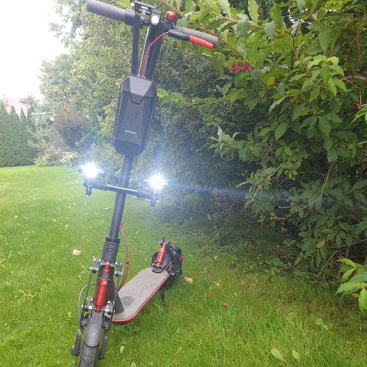 Scooter handrail add-on showing two bright front lights on handlebar