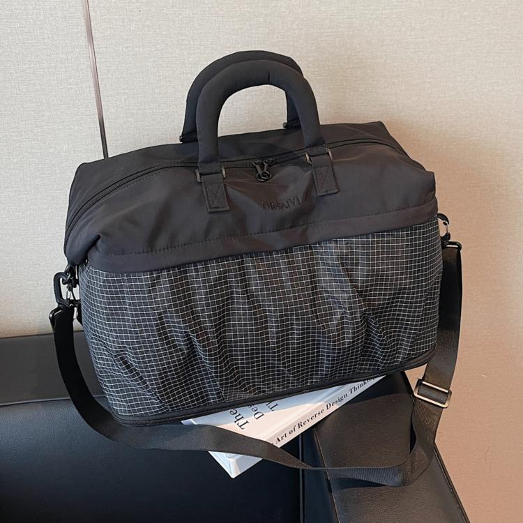 Lightweight duffel bag in dark grey with grid pattern and wide shoulder strap