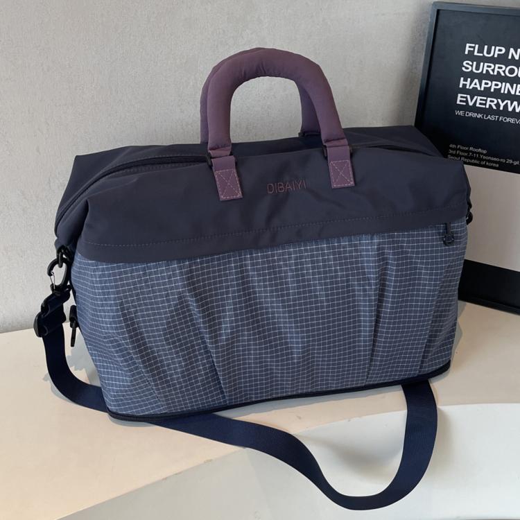 Lightweight duffel bag in dark navy with purple handle accents and shoulder strap