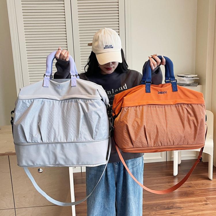 Pair of duffel bags: light grey and orange with top handles and shoulder straps