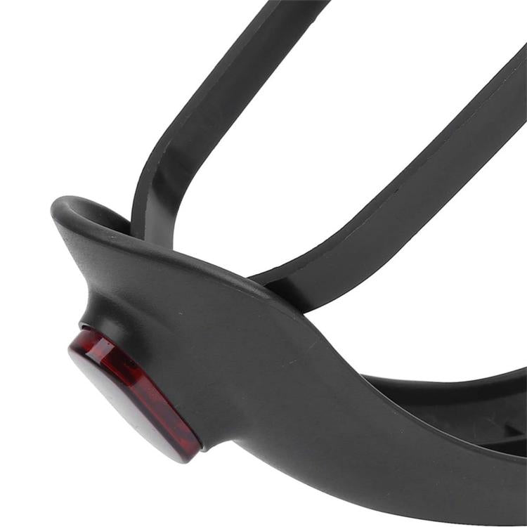 Close-up of black rear mudguard with red tail light and mounting base