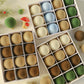 Flocked Christmas ball ornaments with hanging loops in assorted coffee brown, white, green, and light blue