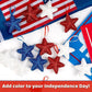 Glitter five-pointed star ornaments in red, white, and blue with red hanging loops