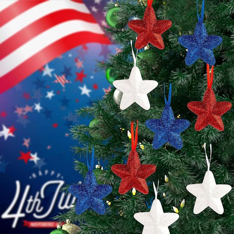 Five-pointed star hanging ornaments in red, blue, and white glitter on tree branches