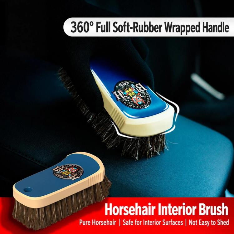 Horsehair interior brush with blue handle on leather seat, angled view