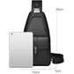 Men’s black PU leather sling bag with front flap pocket holding a phone