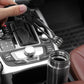 Hand holding a clip-on immersion heater rod beside a car cup container