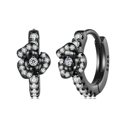 Black-plated hoop earrings with clustered round zircon stones in a cross-like design